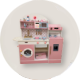 The room is equipped with children's kitchen playsets.